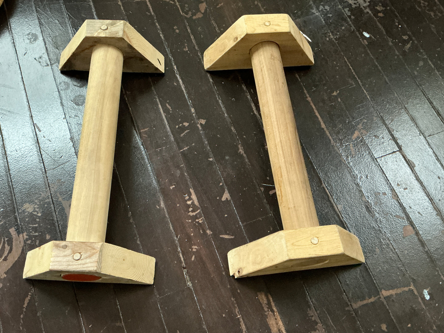 Hand-routed 2-inch thick wooden parallettes for grip strength training by Rough Road Fitness.